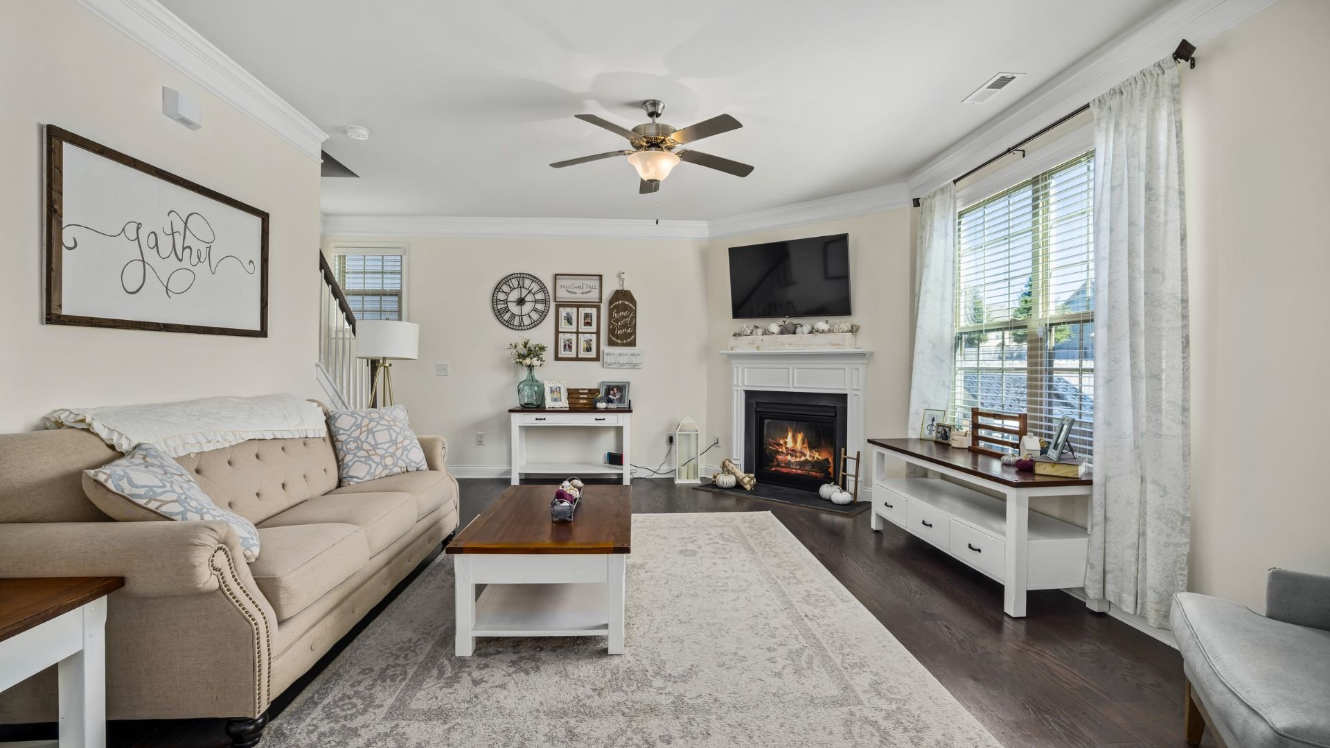 Cozy living room with fireplace, neutral decor, and comfortable seating